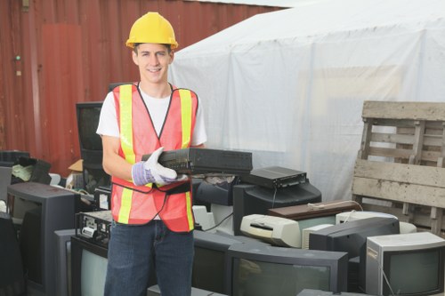 Image of a uniformed clearance team member guiding an occupant during a flat clearance visit.